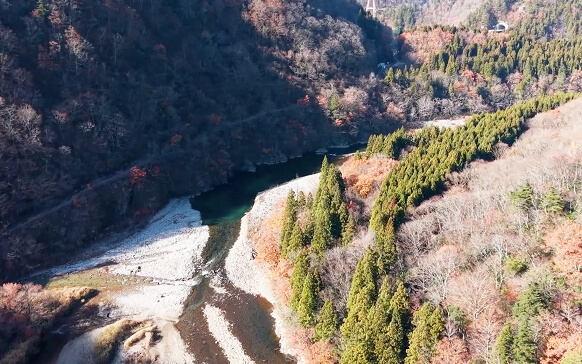 A fast-flowing river cutting through a steep valley in Toyama
